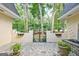 Inviting courtyard with stone patio, brick walls, black metal gate, and lush greenery provides a private outdoor space at 522 Golfview, Peachtree City, GA 30269