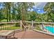 Deck with a beautiful view of the backyard, swimming pool with slide, and lush trees at 522 Golfview, Peachtree City, GA 30269
