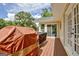 View of wood deck with grill and back of house, including sliding glass doors at 522 Golfview, Peachtree City, GA 30269