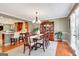 Bright dining room with hardwood floors, chandelier, and access to the kitchen and outdoors at 522 Golfview, Peachtree City, GA 30269