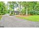 Long driveway leading to a home featuring a lawn, a tree and well-kept landscaping at 522 Golfview, Peachtree City, GA 30269