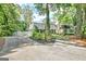A sprawling home with a long driveway, lush greenery, and a glimpse of a white picket fence at 522 Golfview, Peachtree City, GA 30269