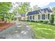 Spacious home with a long driveway, lush green lawn, and mature trees provides a welcoming approach at 522 Golfview, Peachtree City, GA 30269