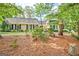 A well-maintained single-story home with black shutters and a well-manicured lawn, exudes curb appeal at 522 Golfview, Peachtree City, GA 30269