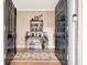 Elegant foyer featuring double black doors, hardwood floors, and a decorative console table with shelf at 522 Golfview, Peachtree City, GA 30269