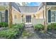 Charming front entrance featuring an iron gate, brick facade, and lush greenery at 522 Golfview, Peachtree City, GA 30269
