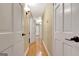 Hallway featuring wood floors, neutral paint, white trim, and doorways to bedrooms and bathrooms at 522 Golfview, Peachtree City, GA 30269