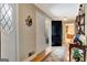 Hallway with hardwood floors, neutral walls, and decorative sconces leads to the kitchen and other rooms at 522 Golfview, Peachtree City, GA 30269