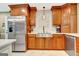 This kitchen showcases custom wood cabinets, stainless steel appliances, and bright tile backsplash at 522 Golfview, Peachtree City, GA 30269