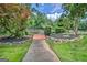 Well-maintained backyard pathway with a wooden bridge and manicured landscaping features at 522 Golfview, Peachtree City, GA 30269