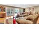 Living room showcasing hardwood floors, fireplace, and access to a relaxing outdoor patio at 522 Golfview, Peachtree City, GA 30269