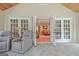 Inviting living room with hardwood floors and access to sunroom through glass paneled french doors at 522 Golfview, Peachtree City, GA 30269