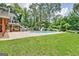 Backyard pool with a slide, spacious patio, and lounge chairs, creating an inviting outdoor retreat at 522 Golfview, Peachtree City, GA 30269