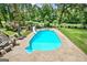 Expansive in-ground pool surrounded by a spacious patio and lush landscaping at 522 Golfview, Peachtree City, GA 30269