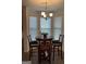 Cozy breakfast nook with a round table, four chairs, and a bay window offering natural light at 13709 Whitman Ln, Covington, GA 30014