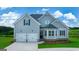 Charming two-story home featuring a two-car garage, landscaped front yard, and a mix of siding textures at 13709 Whitman Ln, Covington, GA 30014