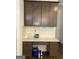 Built in desk area with cabinetry and light countertop at 13709 Whitman Ln, Covington, GA 30014