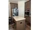 Spacious kitchen with stainless steel appliances and island seating at 13709 Whitman Ln, Covington, GA 30014