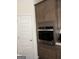 Modern stainless steel kitchen oven installed within wood cabinetry, providing a sleek design at 13709 Whitman Ln, Covington, GA 30014