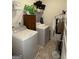 Functional laundry room with washer, dryer, shelving and storage at 13709 Whitman Ln, Covington, GA 30014