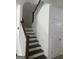 Staircase featuring wood steps, white risers, and white railing leading to the upper level at 13709 Whitman Ln, Covington, GA 30014