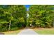 Scenic walking path surrounded by lush trees and greenery at 13709 Whitman Ln, Covington, GA 30014