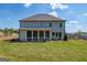 Exterior rear view showcasing a spacious backyard and sunroom at 313 Westfall Ter # 225A, Loganville, GA 30052