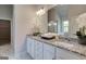 Bright bathroom featuring double vanity with granite countertop and modern fixtures at 313 Westfall Ter # 225A, Loganville, GA 30052