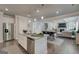 Open kitchen and living area with an island, stainless appliances, and seamless flow for entertaining at 313 Westfall Ter # 225A, Loganville, GA 30052