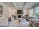 Cozy living room featuring a stone fireplace, coffered ceiling, and comfortable seating at 313 Westfall Ter # 225A, Loganville, GA 30052
