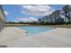 Community pool with ample seating and a nearby building at 313 Westfall Ter # 225A, Loganville, GA 30052