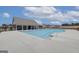 Community pool with ample seating and a nearby building at 313 Westfall Ter # 225A, Loganville, GA 30052