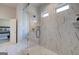 Stunning walk-in shower with marble tile and a sleek glass enclosure at 313 Westfall Ter # 225A, Loganville, GA 30052