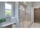 Luxurious marble shower with frameless glass door and adjacent bench at 313 Westfall Ter # 225A, Loganville, GA 30052