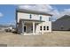 Exterior rear view of a two-story home with a covered patio and a yard ready for landscaping at 605 Somerset Ct # 161A, Loganville, GA 30052