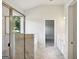 Bright bathroom featuring a glass shower, soaking tub, and marble flooring with white cabinets and quartz countertop at 605 Somerset Ct # 161A, Loganville, GA 30052