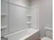 Neutral bathroom with a combined tub and shower and tiled walls at 504 Clayborne Way # 248A, Loganville, GA 30052