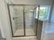 Beautiful bathroom featuring a tile shower with glass doors and a large soaking tub under a window at 504 Clayborne Way # 248A, Loganville, GA 30052