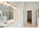 Bright bathroom featuring double sinks, a shower with glass doors, and marble tile flooring at 504 Clayborne Way # 248A, Loganville, GA 30052
