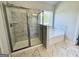 Bathroom with tile shower, glass doors, and large soaking tub providing comfort and luxury at 504 Clayborne Way # 248A, Loganville, GA 30052