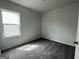 Bedroom with neutral walls, carpeted floors, and a large window at 504 Clayborne Way # 248A, Loganville, GA 30052