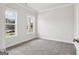 Well-lit bedroom with two large windows providing ample natural light and neutral carpet at 504 Clayborne Way # 248A, Loganville, GA 30052