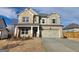 Charming two-story home featuring a two-car garage, stone accents and a well-maintained lawn at 504 Clayborne Way # 248A, Loganville, GA 30052