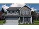 Charming two-story home with brick and gray siding, featuring a two-car garage and manicured lawn at 504 Clayborne Way # 248A, Loganville, GA 30052