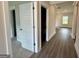 Bright hallway featuring sleek wood flooring, white trim, and access to various rooms at 504 Clayborne Way # 248A, Loganville, GA 30052