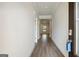 Hallway featuring sleek wood flooring and white walls, leading into open living spaces at 504 Clayborne Way # 248A, Loganville, GA 30052