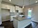 Modern kitchen with granite countertops, stylish backsplash, and an island with pendant lighting at 504 Clayborne Way # 248A, Loganville, GA 30052