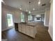Charming kitchen with granite counters, stainless faucet and decorative lighting, flowing into the living room at 504 Clayborne Way # 248A, Loganville, GA 30052