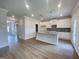 Bright kitchen features an island, granite counters, pendant lights, and white cabinetry at 504 Clayborne Way # 248A, Loganville, GA 30052