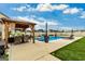 Inviting backyard featuring a pool, covered dining area, lounge chairs and well-manicured lawn at 209 Osier Dr, Mcdonough, GA 30252